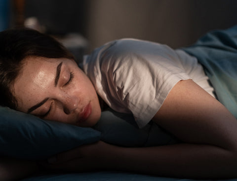 Young women sleeping to help manage period symptoms
